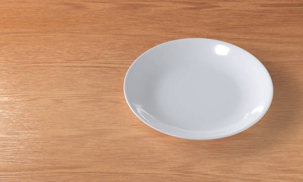 istock Blank white ceramic plate on a wooden table 1252292942