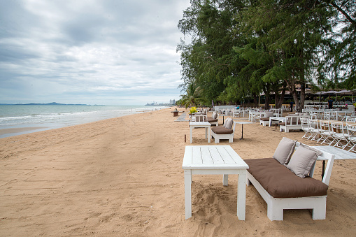 White wooden table set on sand beach
