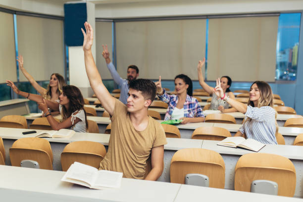 istock Group of students raising hands in class on lecture 1252297047