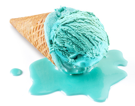 Blue melted ice cream in waffle cone on white background. Melt ice cream puddle near cone with ice. Close -up.