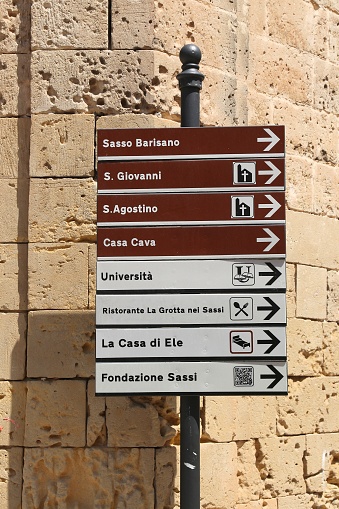 Landmark direction signs in Matera, Italy. The Old Town is listed as a UNESCO World Heritage Site.