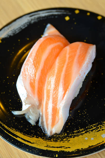 istock Salmon Sushi on black plate 1252311012