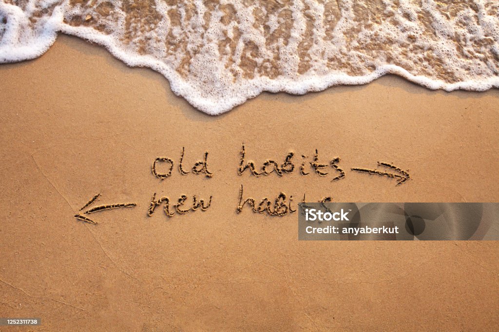 old habits vs new habits, life change old habits vs new habits, life change concept written on sand Addiction Stock Photo