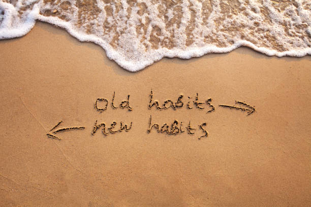 old habits vs new habits, life change old habits vs new habits, life change concept written on sand addiction stock pictures, royalty-free photos & images