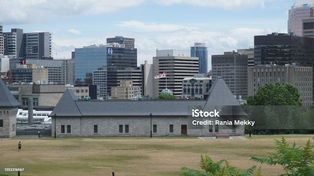 a combination of old and modern architecture at the same scene. Montreal, QC/ Canada - 6/24/2020: a combination of old and modern architecture at the same scene. An old historical building at the Rutherford park with a background of modern buildings McGill University Stock Photo