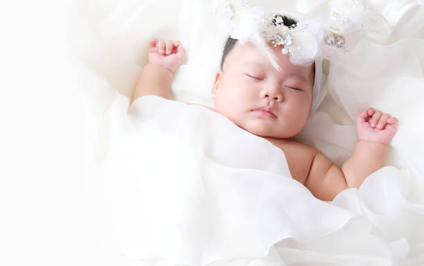 istock Cute newborn baby sleep on white fabric background. 1252317962