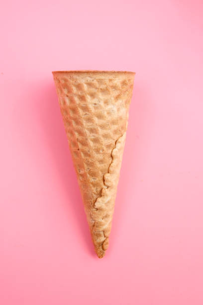istock Empty ice cream waffle cones on pink background. Flat lay top view. Minimal decorative holiday concept. 1252318321