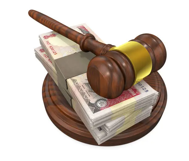 Judge gavel and stack of rupee bills