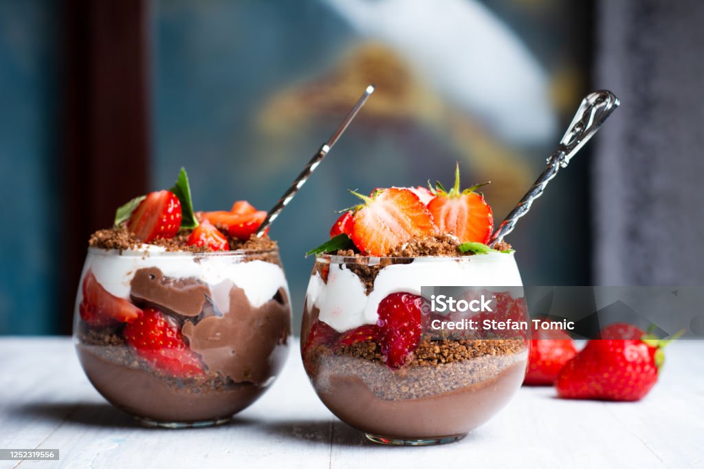 Strawberry parfait dessert in a glass cup with cream and chocola Strawberry parfait dessert in a glass cup with cream and chocolate closeup Dessert - Sweet Food Stock Photo