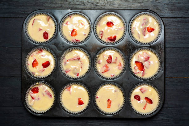 istock Raw muffin dough with fruit in a mold ready for baking 1252319613