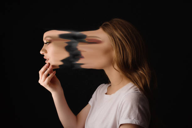 Who am I? Profile view of blond woman holding mask (face), feeling confused and contemplative mask disguise photos stock pictures, royalty-free photos & images