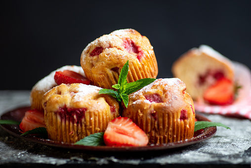 Fresh baked Vanilla cupcakes with mint, selective focus, copy space