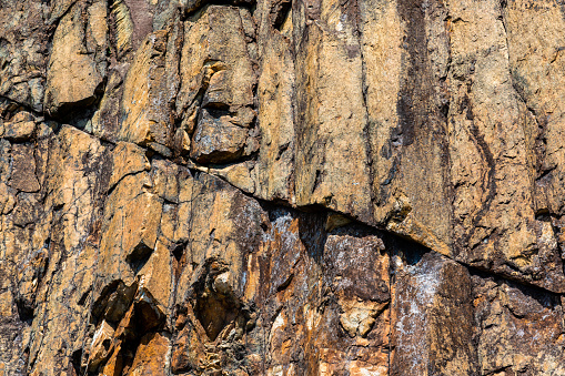 Copper mineralised rock pile, rubble tailings, close with shallow depth of field.