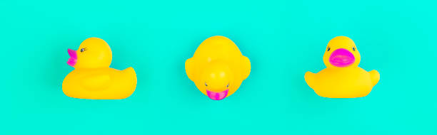 istock Yellow rubber duck on blue background 1252324217