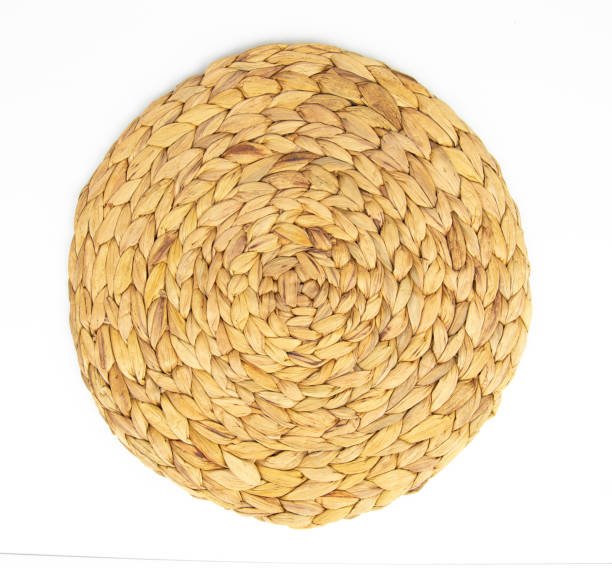Round woven wicker straw mat isolated on white background