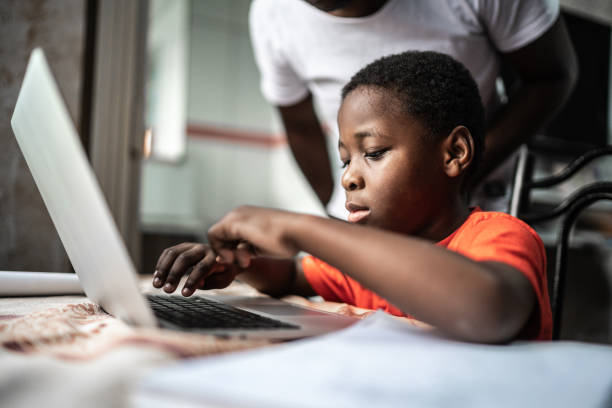 istock Father and son studying with laptop on a online class at home 1252331399