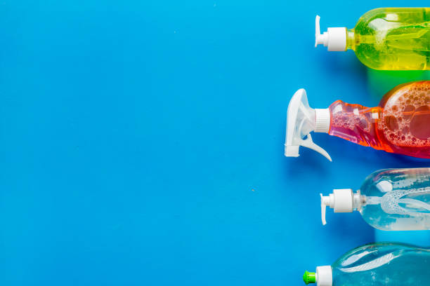 istock Cleaning products bottles on blue background top view copy space 1252334122