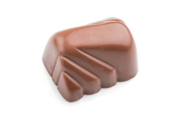 istock Single chocolate candy isolated on white background. side view, close up. 1252337578