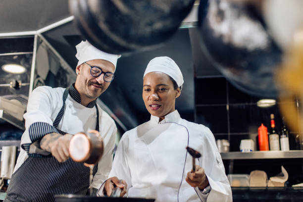 istock Chef teaching his new employee how to prepare a dish 1252338137