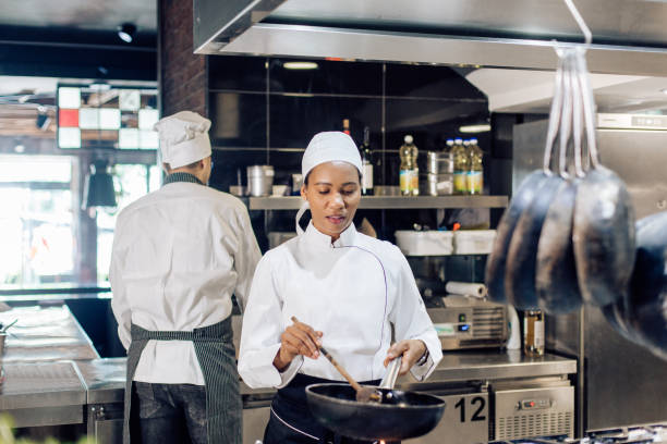 istock Young woman cooking at the restaurant kitchen 1252338140