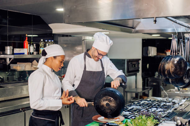 istock Chef and his employee preparing a meal together 1252338576