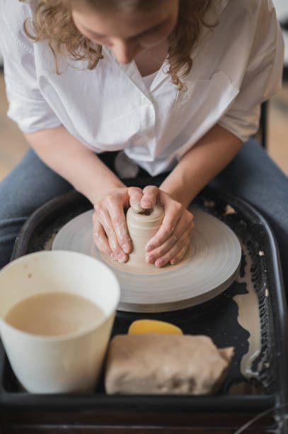 istock Hands of a potter, creating an earthen jar on the circle 1252339339