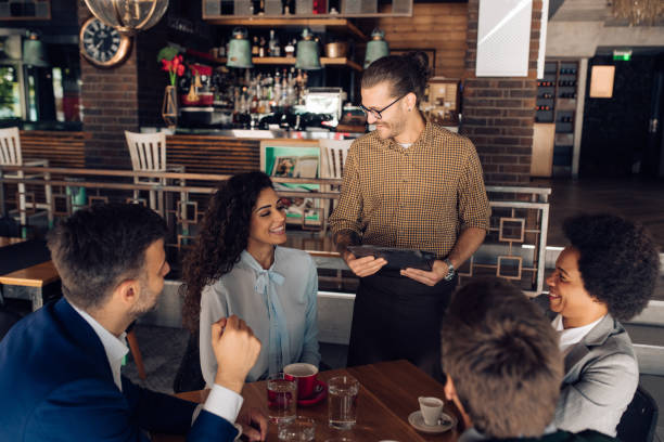 istock Group of colleagues ordering their meal at the restaurant 1252339377