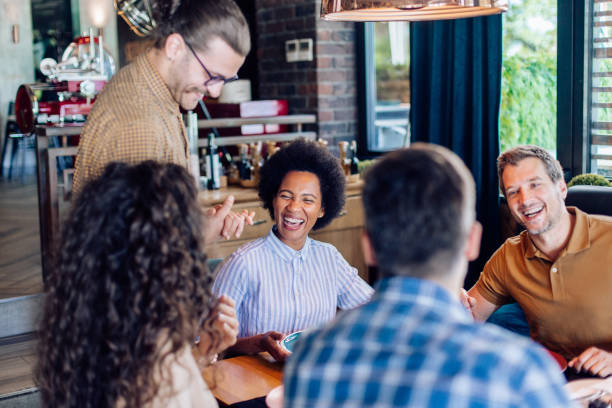 istock Group of colleagues having fun while making their order at the restaurant 1252339654