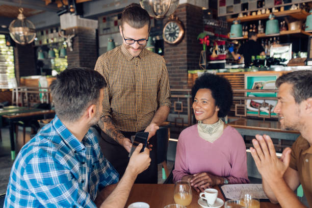 istock Businessman making an electronic payment for a drink 1252339697