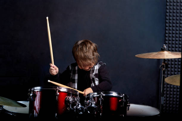 istock Beautiful brunette boy is rehearsing before a performance. Blue background. 1252341602