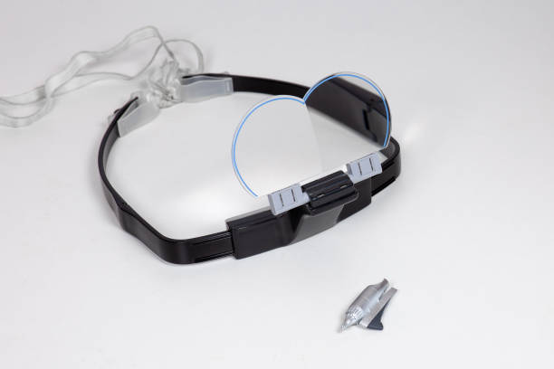 istock Special protective glasses wearing on forehead with folding lenses, for modelling hobby or painting works with little details. Part of assembled plane model in front of. 1252350283