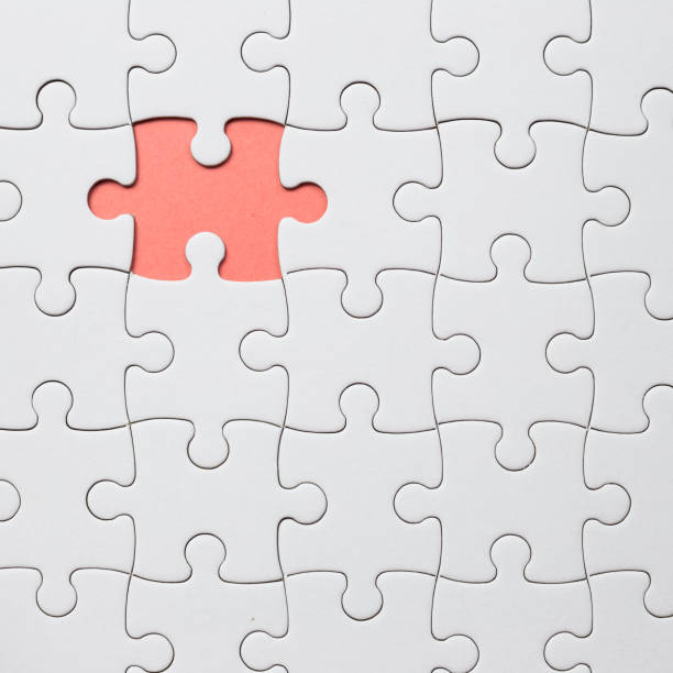 istock Set of white puzzle pieces and last one piece 1252359851