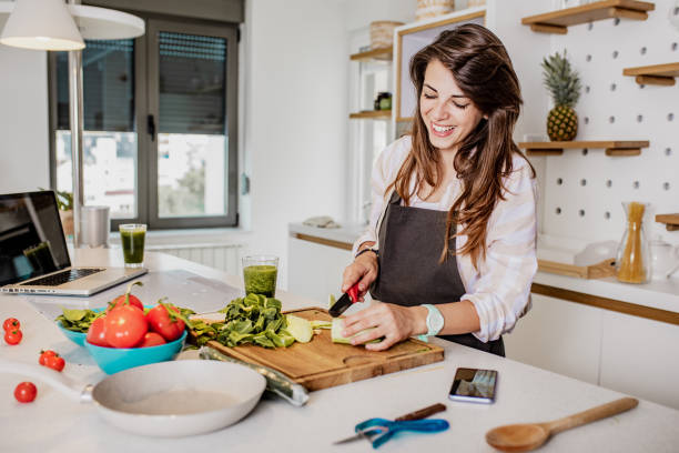 istock Young woman prepares a healthy drink in kitchen 1252359890