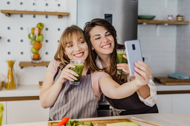 istock Two young female friend taking a selfie in the kitchen 1252361521