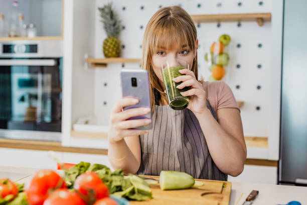 istock Young woman is in the kitchen and she is using mobile phone 1252362127