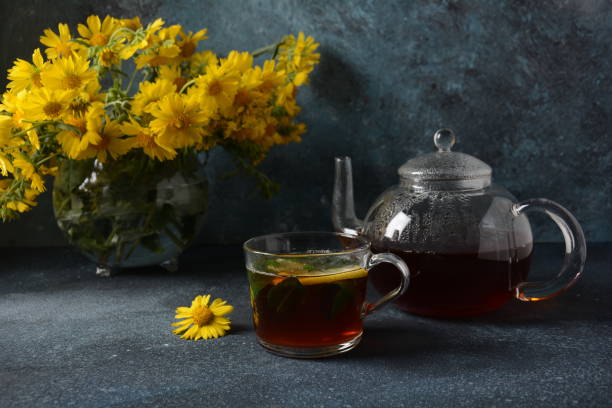 istock Glass teapot  and a glass mug with black tea. 1252368991