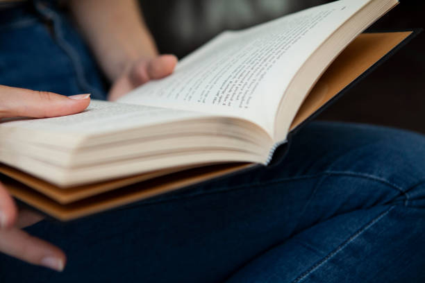 istock Close-up of hands holding a book 1252369825