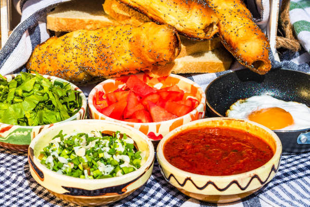 istock Rustic composition with sausages rolls and different bowls with sauce and chopped vegetables ( tomatoes, green lettuce, green onion, green garlic) 1252375138