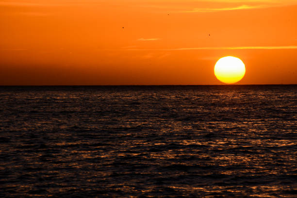 istock The  Sun Setting in the Sea 1252379979