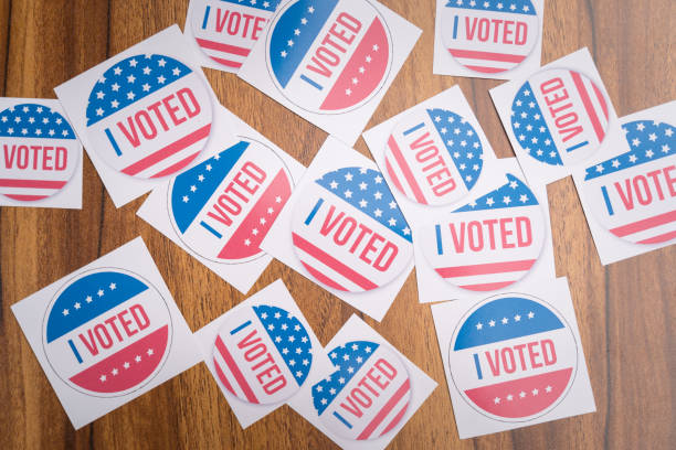 Multiple I Voted stickers on table - concept of voter fraud showing many I voted stickers. Multiple I Voted stickers on table - concept of voter fraud showing many I voted stickers senator photos stock pictures, royalty-free photos & images