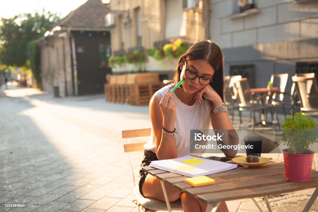 Female student 20-year-old European woman studing in the cafeteria. University Stock Photo