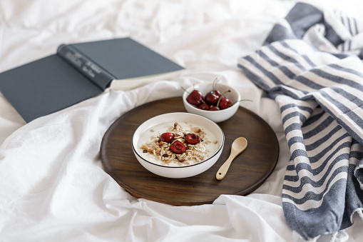 Breakfast, fruit, dairy product, serving tray, wood, bedspread, white, hygge, home office, computer, spoon, book