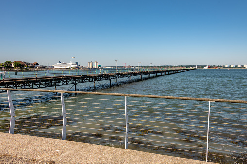 Hythe, UK. Wednesday 35 June 2020. Looking down Hythe Pier in Hampshire, connecting to Southampton (in the background).