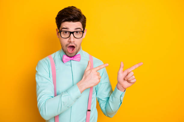 istock Omg look covid-19 novelty subscribe. Astonished guy indicate incredible information direct point index finger copyspace wear good look outfit isolated over vivid color background 1252383518