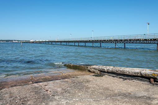 Eastbourne Pier and Beach with a clear blue sky and calm seas, Eastbourne, England