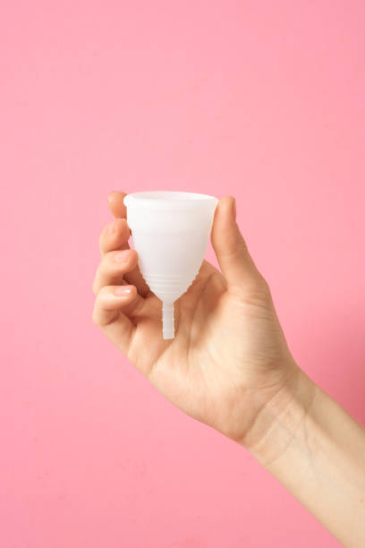 istock Menstrual cup eco friendly reusable and silicone in woman's hand isolated on a white background 1252392606