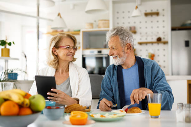 istock Senior couple having breakfast together and using digital tablet 1252393973