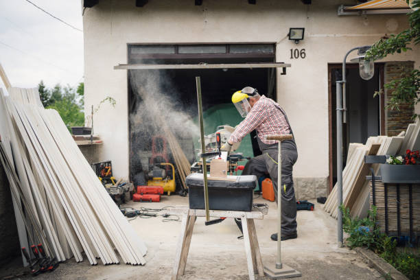 istock Senior carpenter cuts boards to make a fence 1252394236
