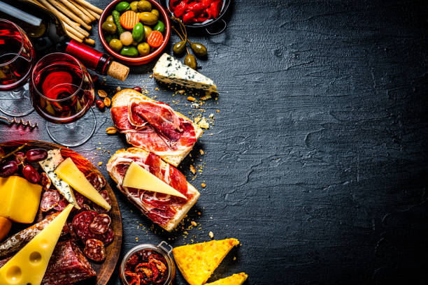 istock Tapas and red wine background on black table. Copy space 1252394688