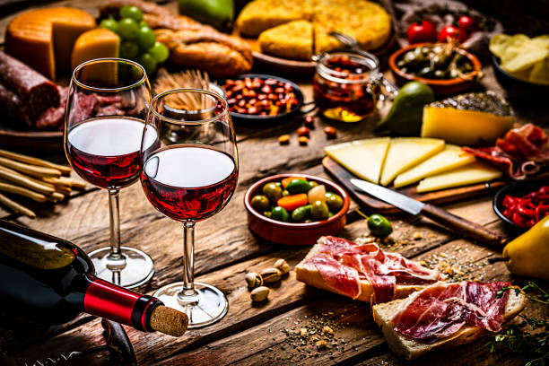 Delicious appetizer with red wine on rustic wooden table